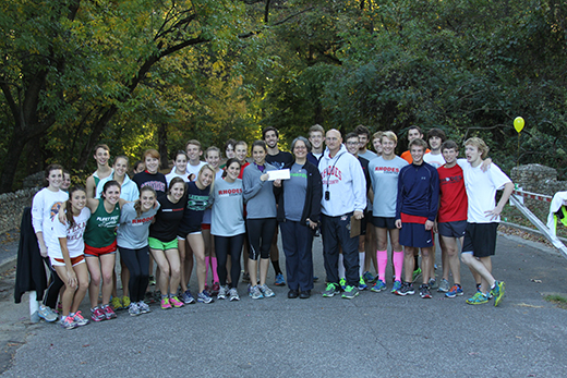 Rhodes College runners present a check to the Overton Park Conservancy