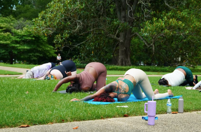 Participants do yoga in the formal gardens