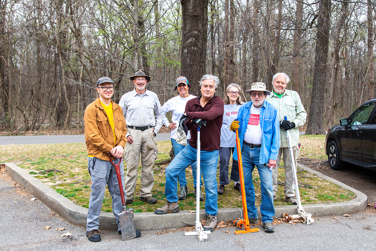 A group of volunteers with plant removal tools