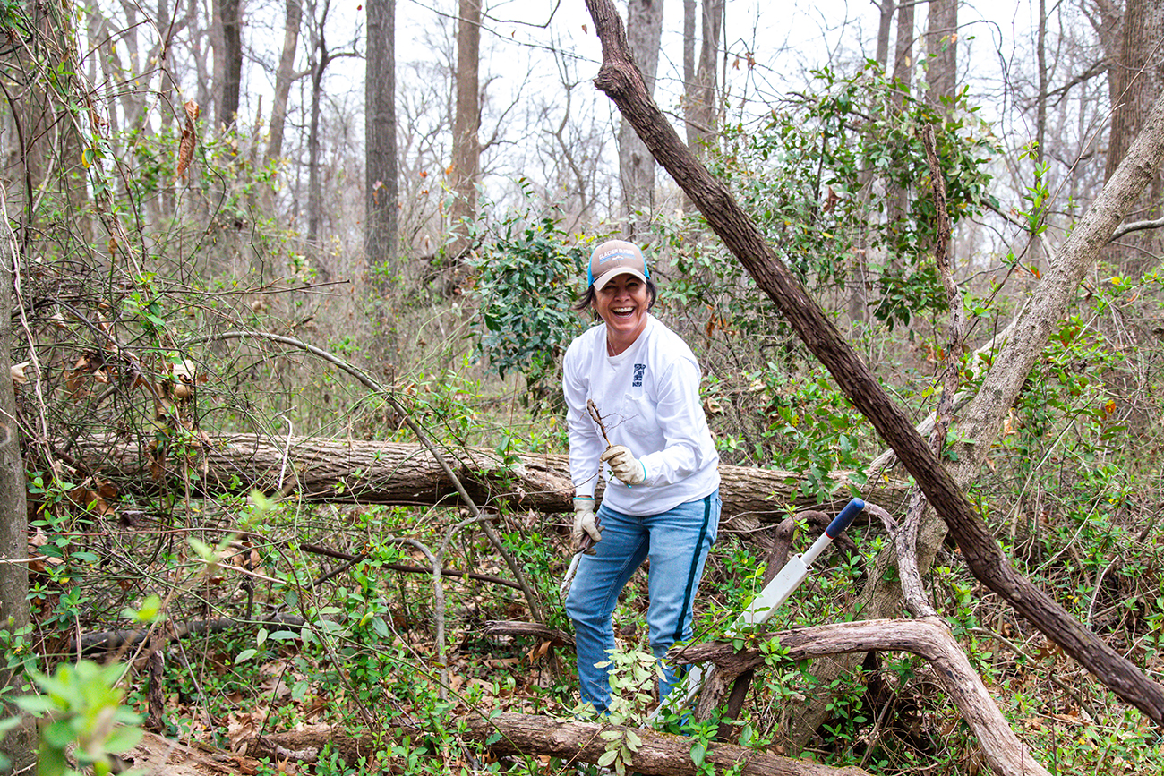 Invasive Avengers create a healthier forest at Overton Park Conservancy | 2 A woman removes invasive plants